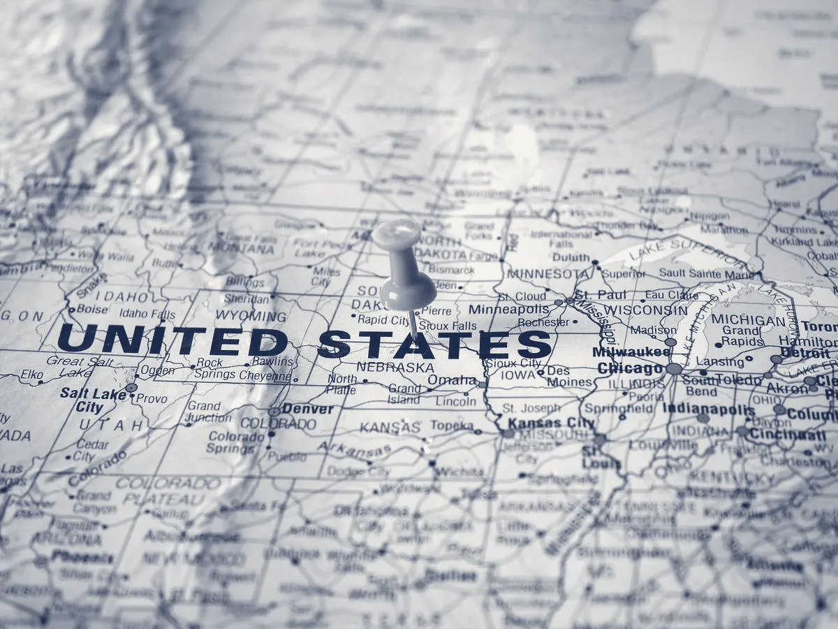A stylized map of the United States, in JAG's navy-and-paper duotone.