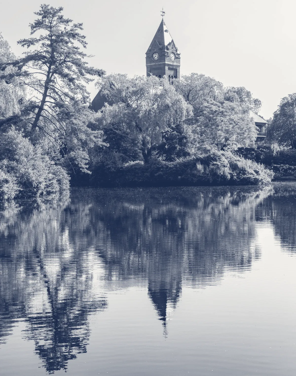 A New England town hall reflected in still water, in JAG's navy-and-paper duotone.